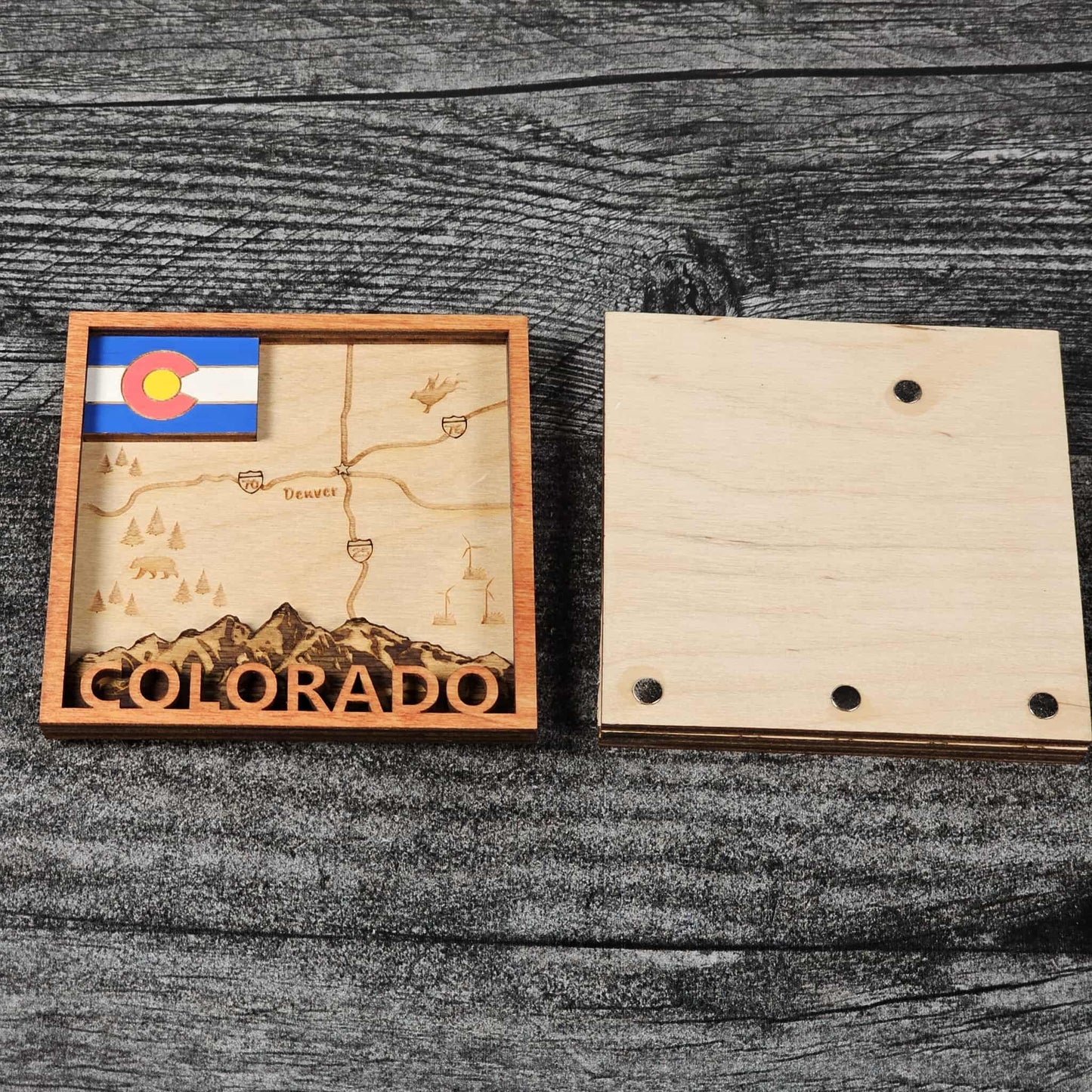 Wooden puzzle piece with Colorado map and flag on a wooden surface