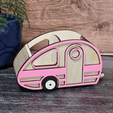 Load image into Gallery viewer, Wooden model of a camper van with pink and beige design on a wooden surface.