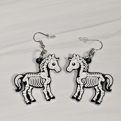 Horse skeleton earrings on a light gray background
