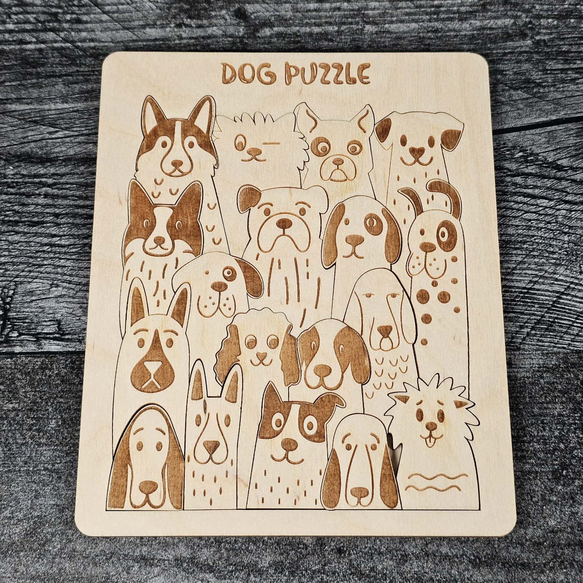 Wooden puzzle with illustrations of dogs on a wooden surface