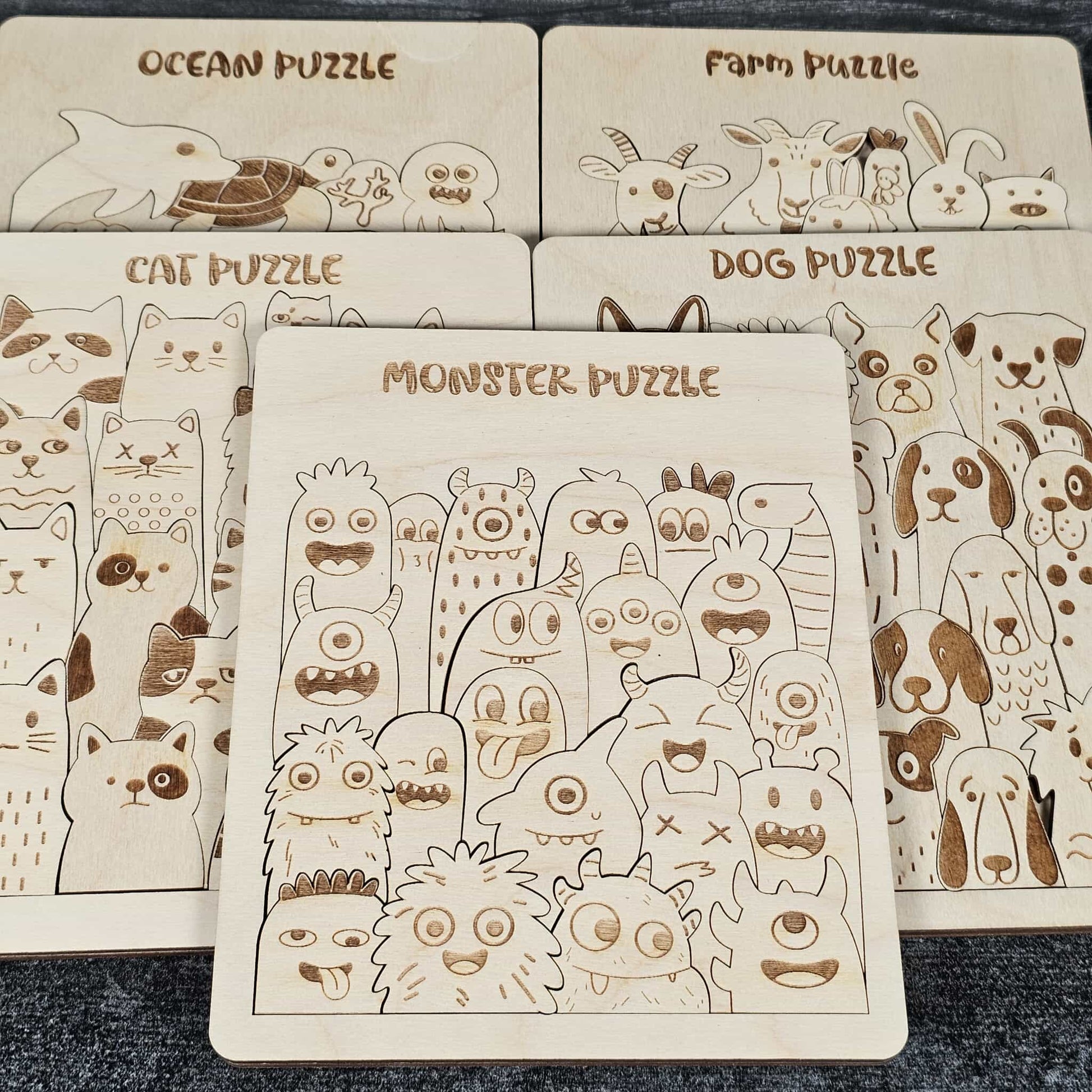 Set of wooden puzzles with different animal themes on a dark surface.