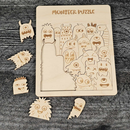 Wooden monster puzzle with pieces on a dark wooden surface