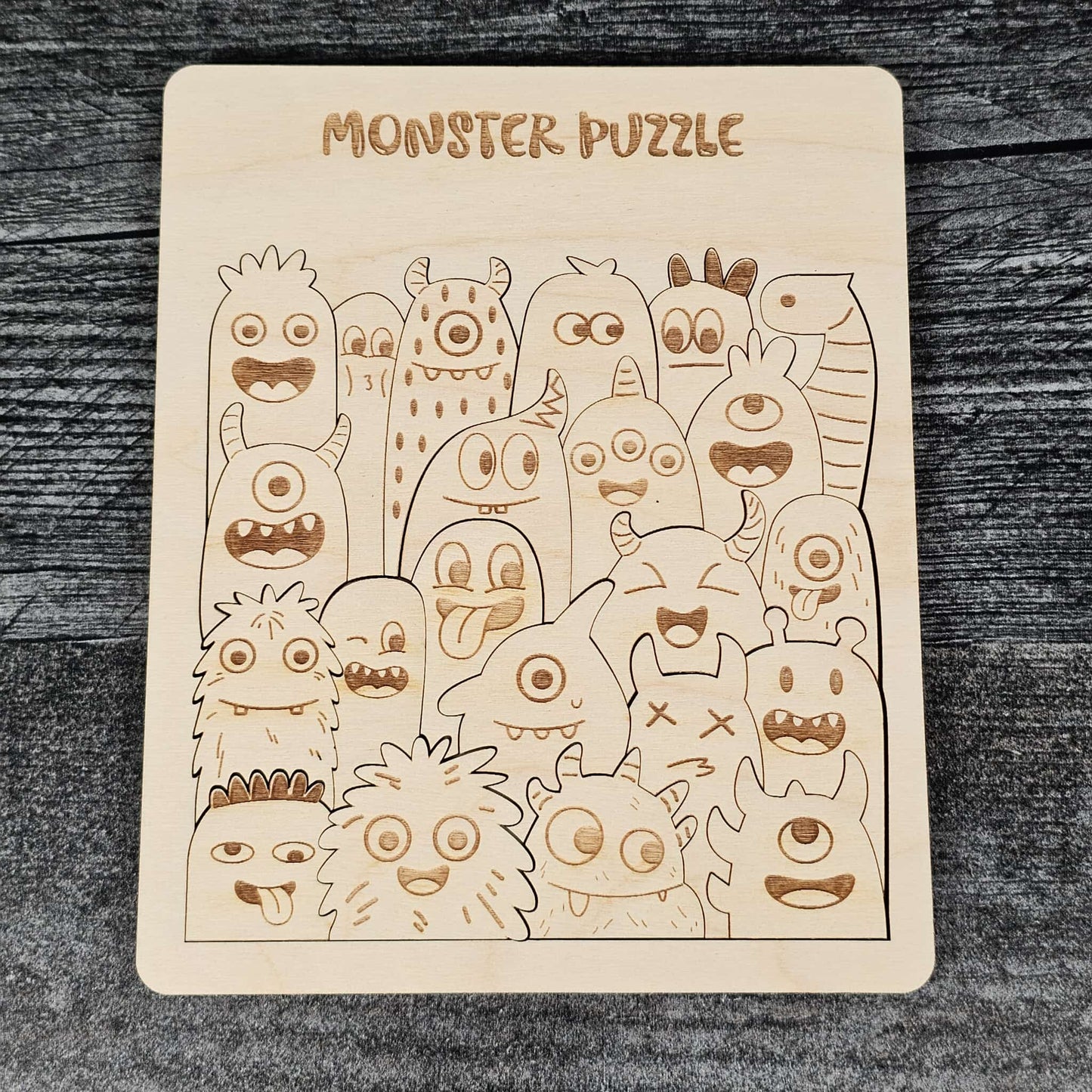 Wooden monster puzzle on a dark wooden surface