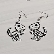 Load image into Gallery viewer, T-Rex skeleton earrings on a white background
