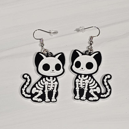 Cat skeleton earrings on a white background