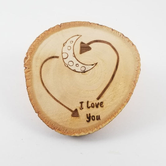 Wooden heart with 'I Love You' engraving on a white background