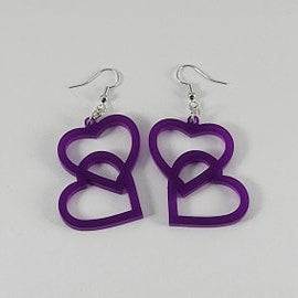 Purple heart-shaped earrings on a gray background