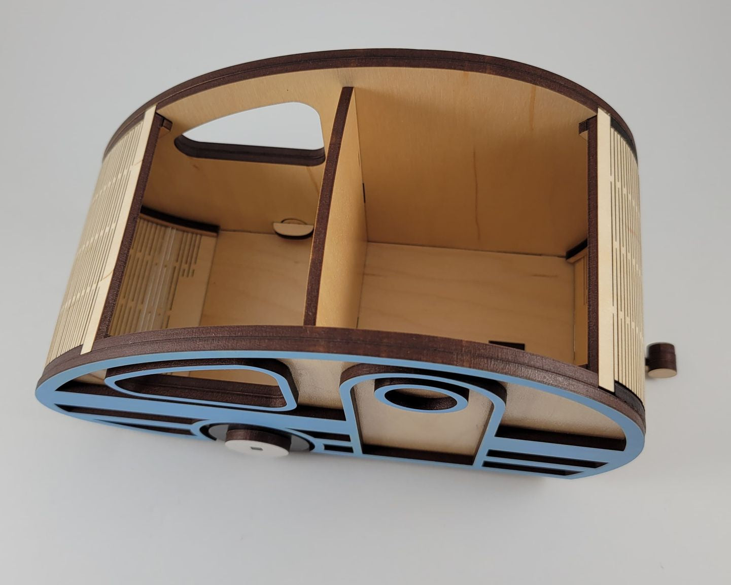 Wooden camper organizer with a curved design on a white background