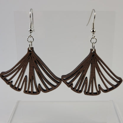 A pair of brown ginkgo leaf-shaped earrings with silver hooks and a silicone backing, displayed against a white background.