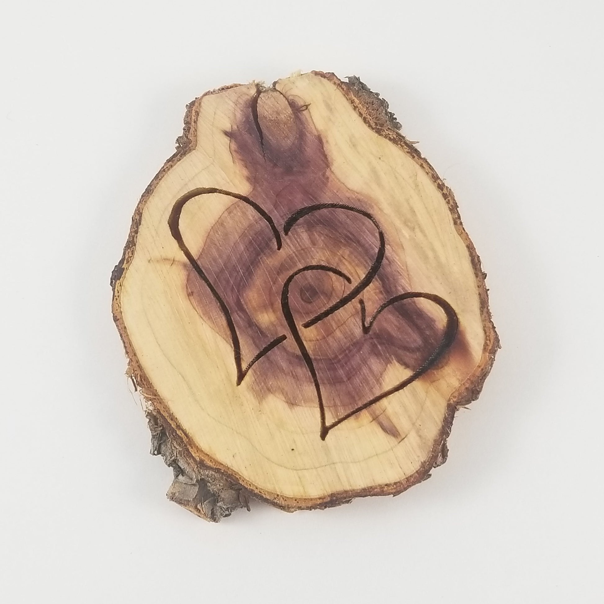 Wooden slice with a heart design on a white background