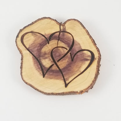 A double heart-shaped wooden ornament with a purple center, on a white background.
