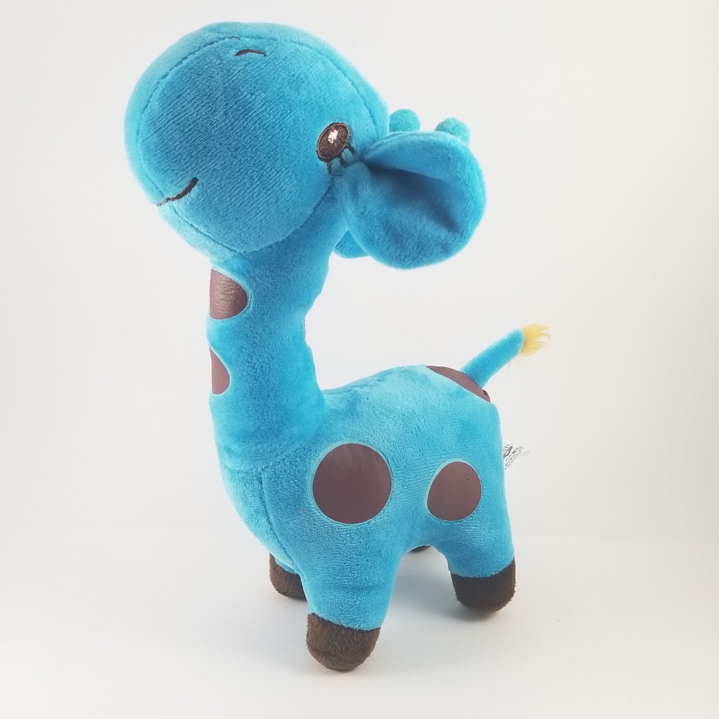 Blue plush giraffe toy on a white background