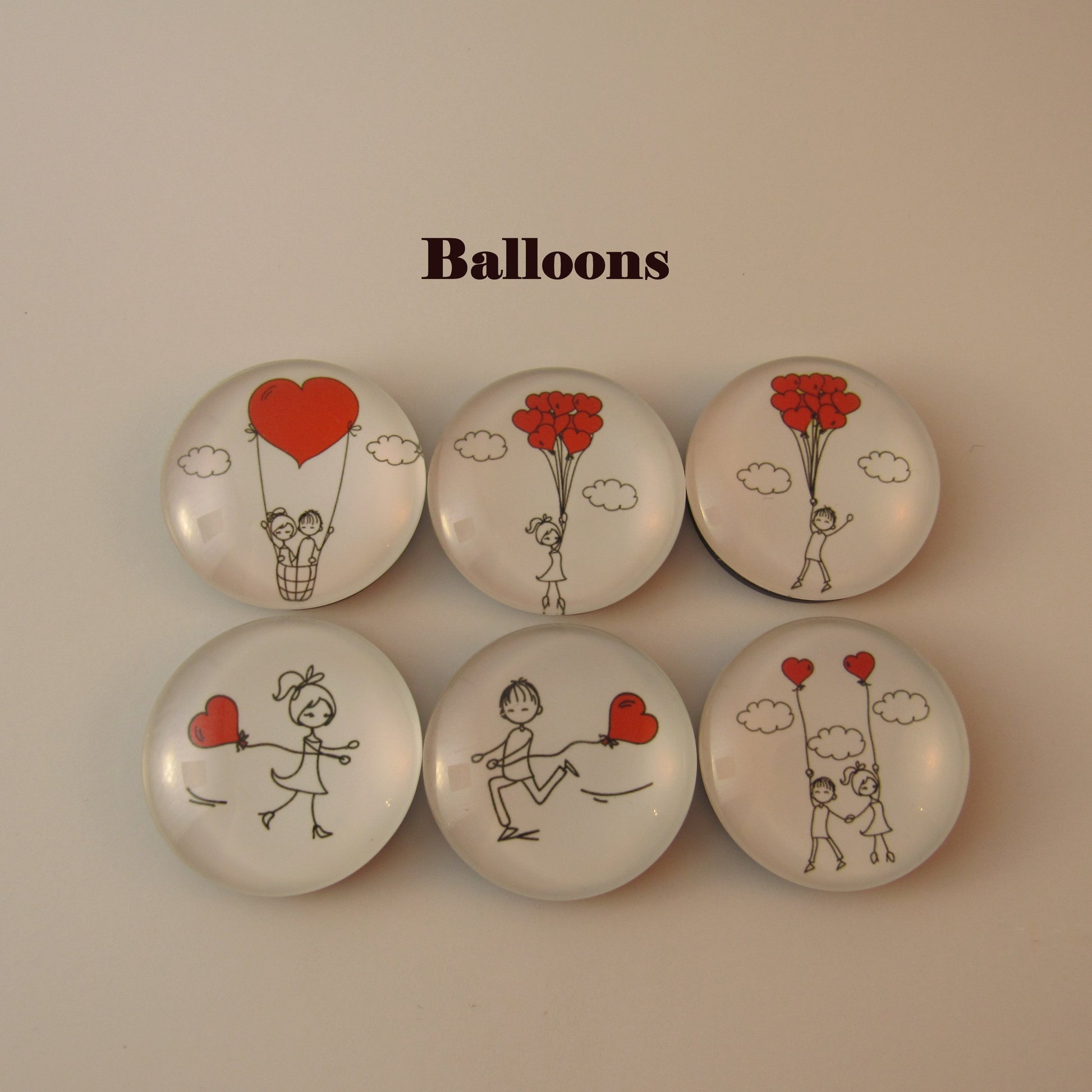 Set of six circular buttons with illustrations of people holding red balloons on a beige background.