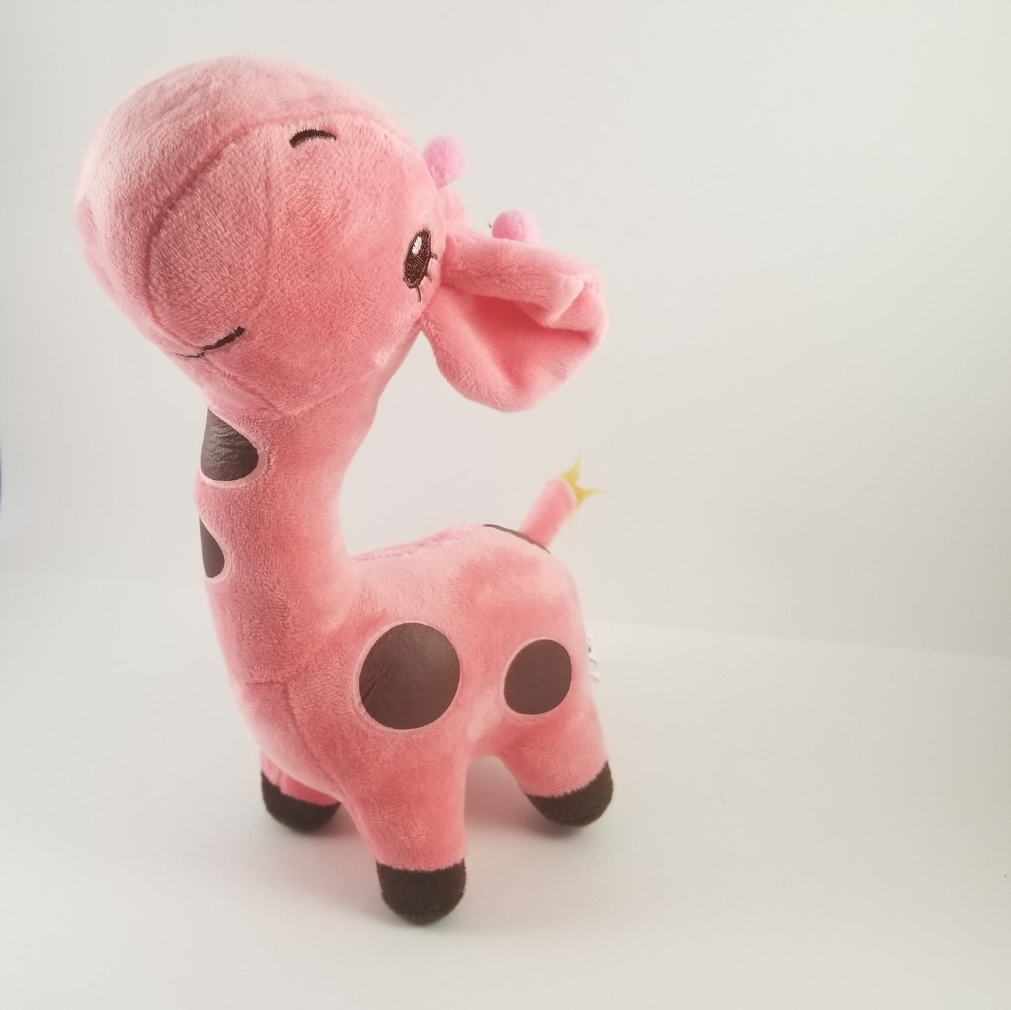 Pink plush toy giraffe on a white background